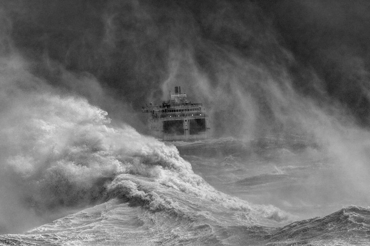 Ferry leaving Newhaven harbour in storm, East Sussex, England
