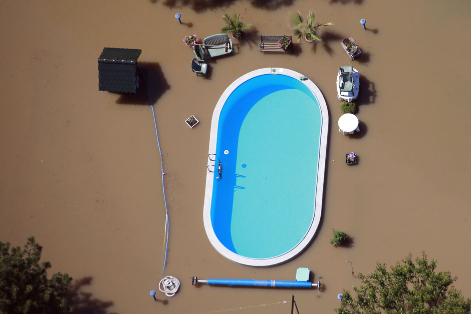 Garden with swimming pool is inundated by waters of Elbe river during floods near Magdeburg