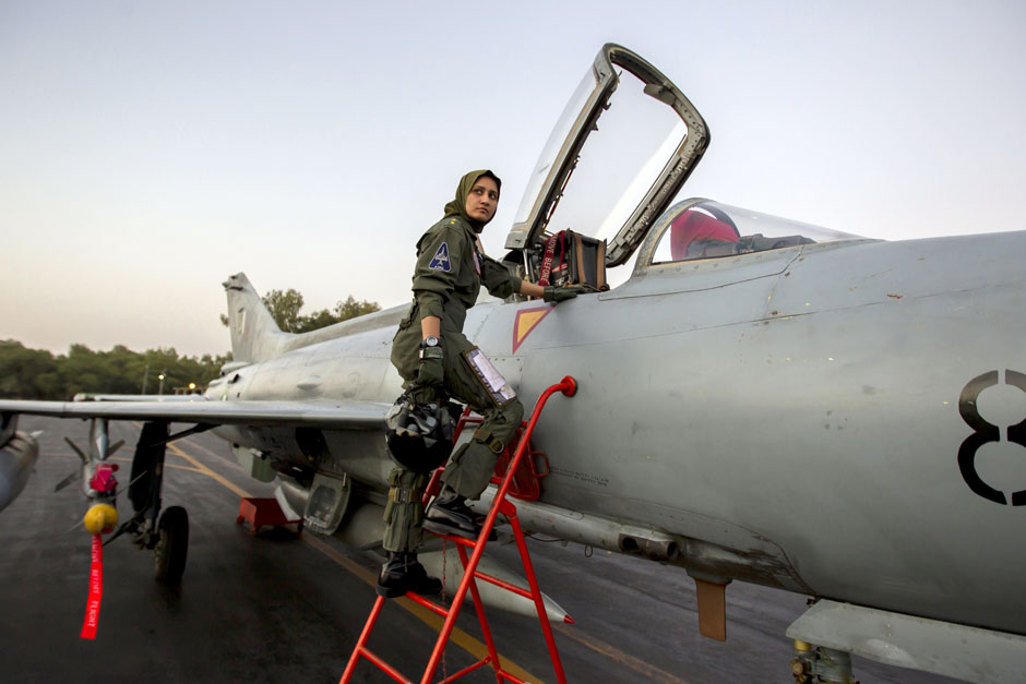 Ayesha Farooq, 26, Pakistan's only female war-ready fighter pilot, climbs up to a Chinese-made F-7PG fighter jet at Mushaf base in Sargodha