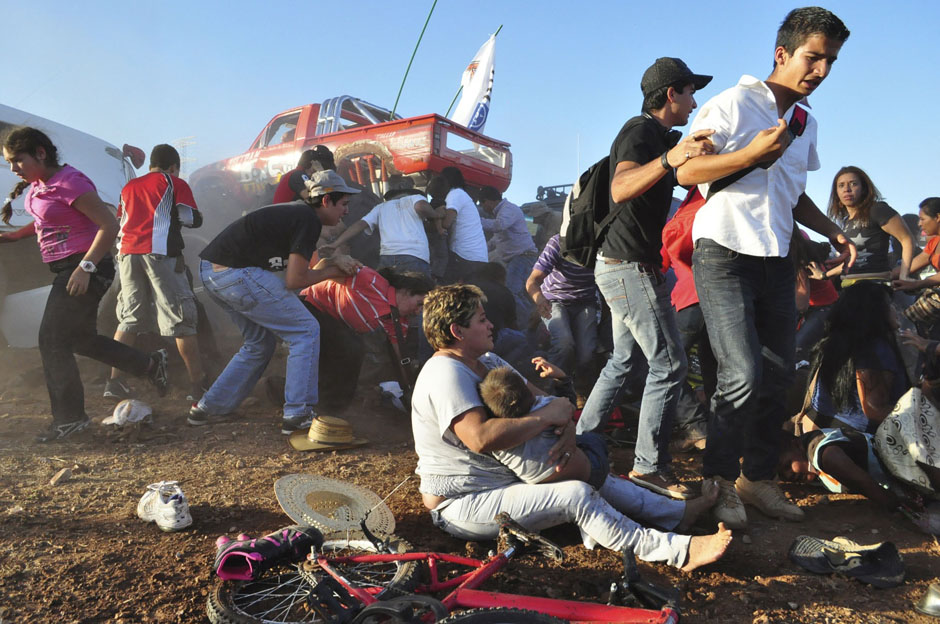 Spectators react after a monster truck rammed the stand where they were watching a monster truck rally show at El Rejon park, Chihuahua