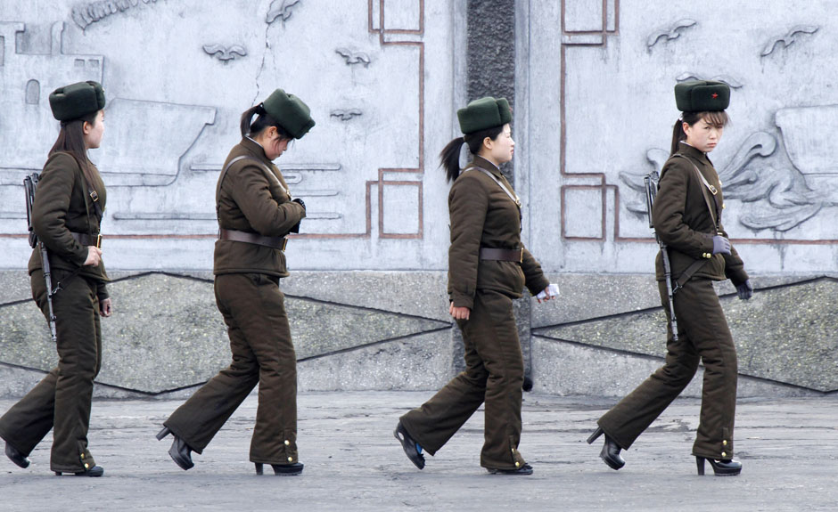 Female North Korean soldiers patrol along the banks of Yalu River, near the North Korean town of Sinuiju