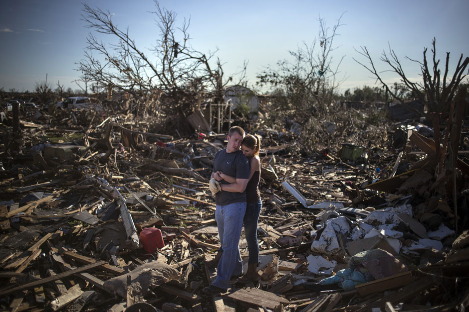 Danielle Stephan holds boyfriend Thomas Layton as they pause between salvaging through the remains of a family member's home one day after a tornado devastated the town Moore, Oklahoma