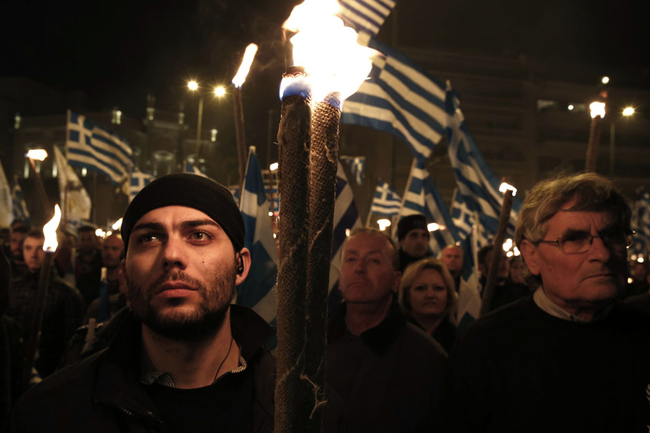 Supporters of the extreme-right Golden Dawn party hold torches during a gathering in Athens