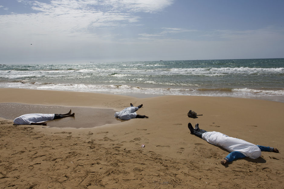 Bodies of migrants who drowned lie on the beach in the Sicilian village of Sampieri