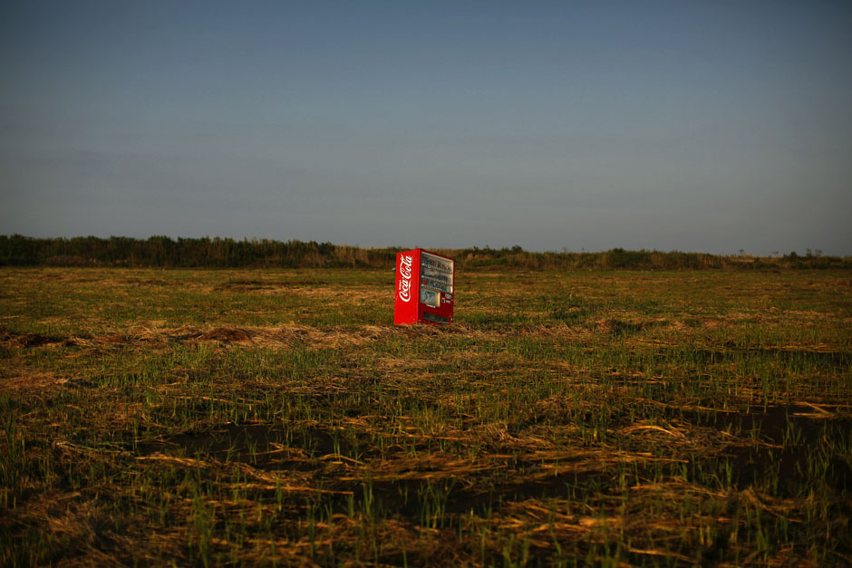 A vending machine, brought inland by a tsunami, is seen in a abandoned rice field inside the exclusion zone at the coastal area near Minamisoma in Fukushima prefecture