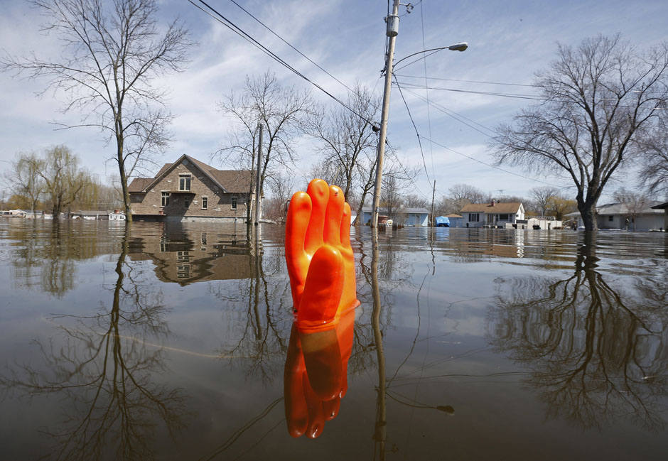 A rubber glove being used as a marker bobs in the water after flooding in Fox Lake, Illinois