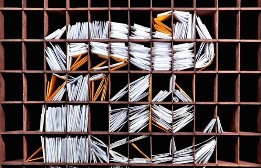 NY Times Logo with Stacks of Mail