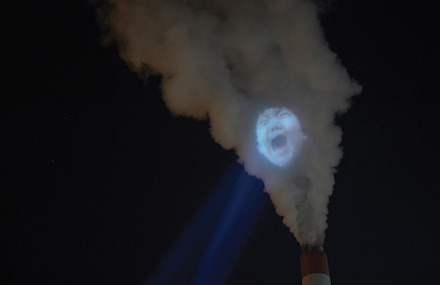Faces Projected on Air Pollution Smoke