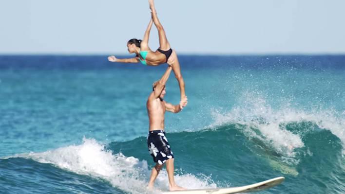 Two Gymnasts on One Surfboard