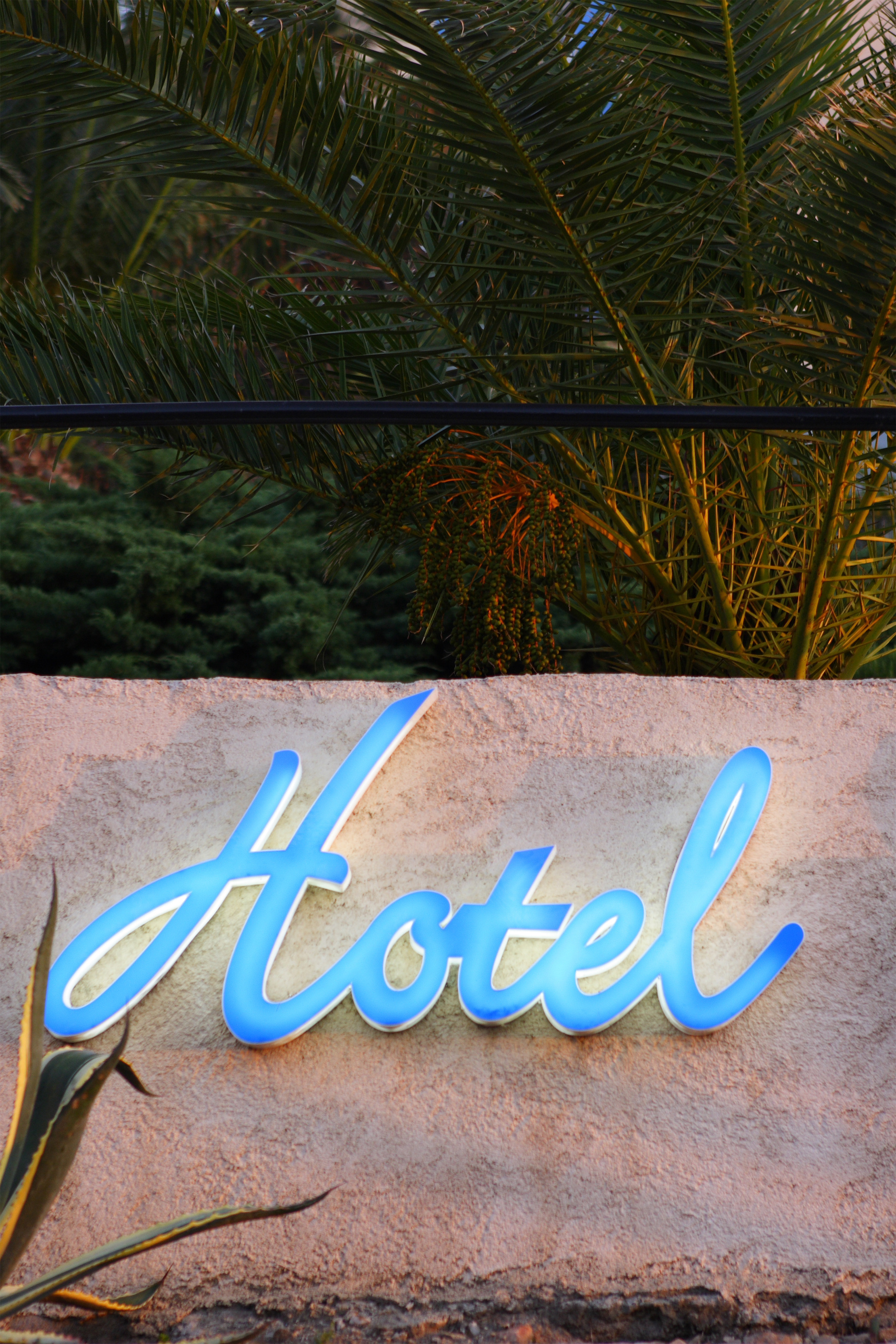 blue hotel sign on wall