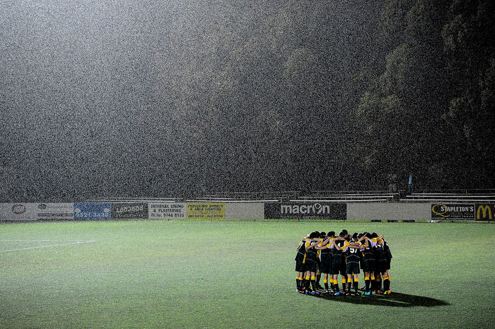 Even When the Rain Falls. Sports teams gather and play across Australia despite the weather. (Photo by John Appleyard:Australian Life Prize 2015)