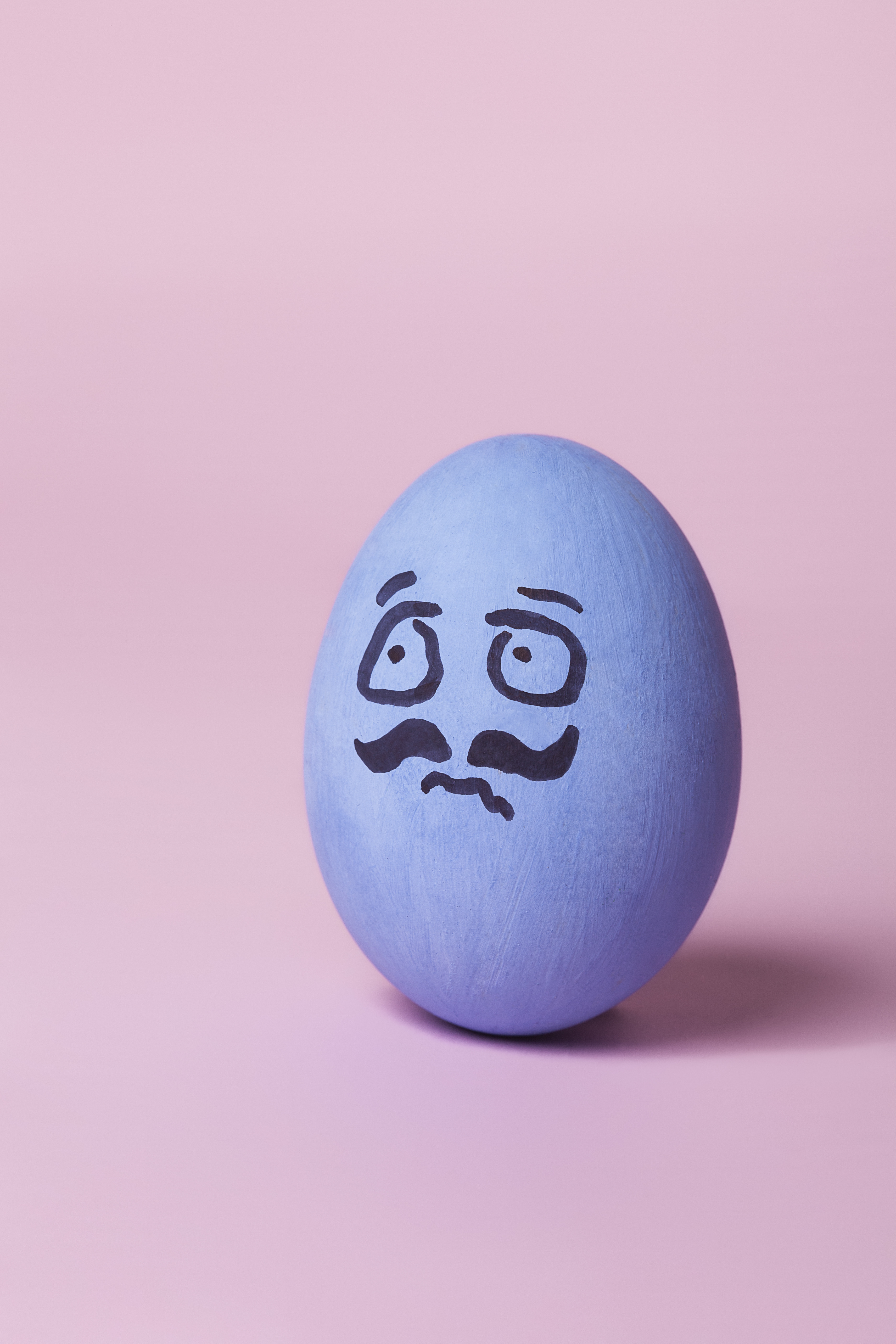 Scared blue painted egg with mustache