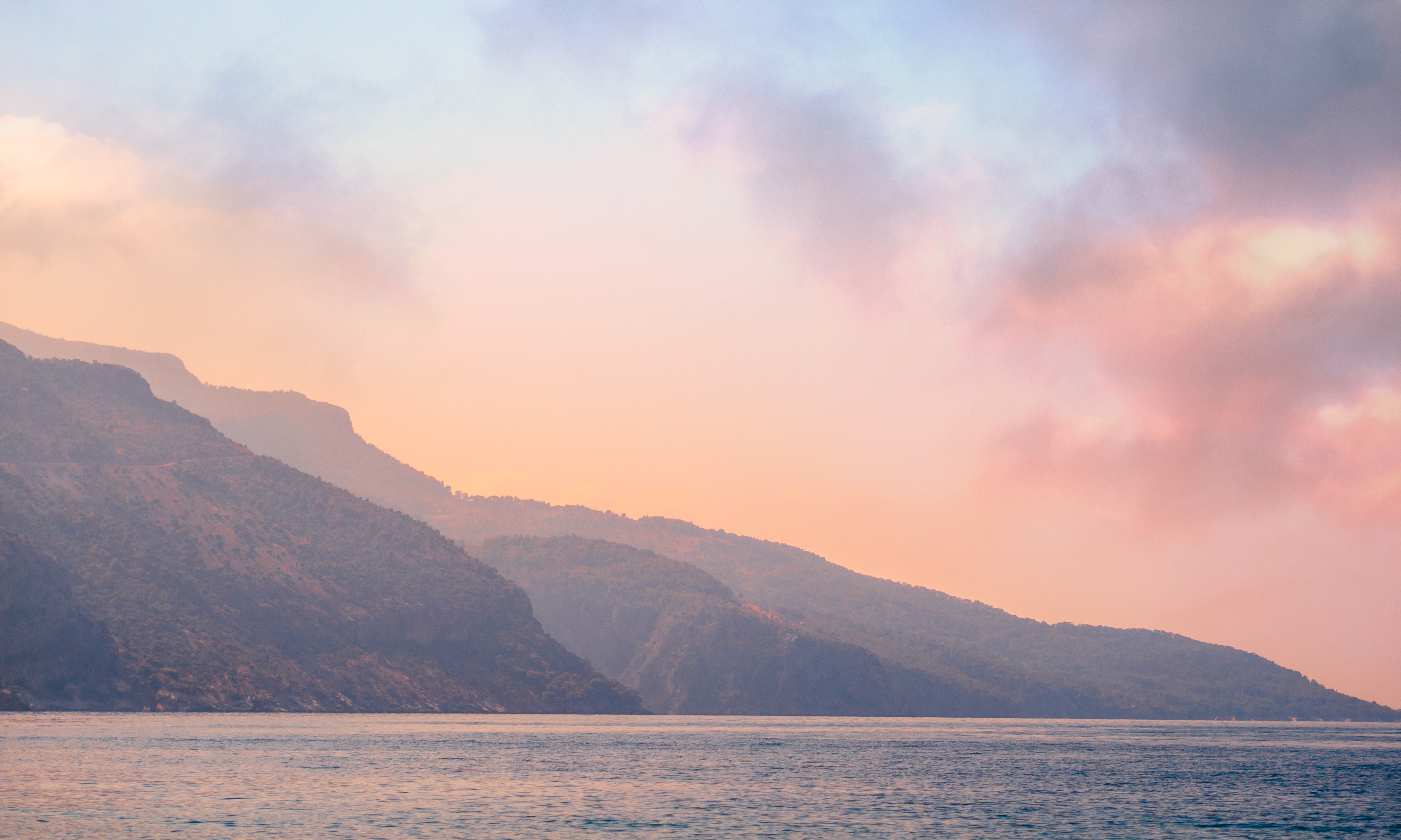 Mountains landscape on the coast at sunrise - serenity and rose quartz colors.