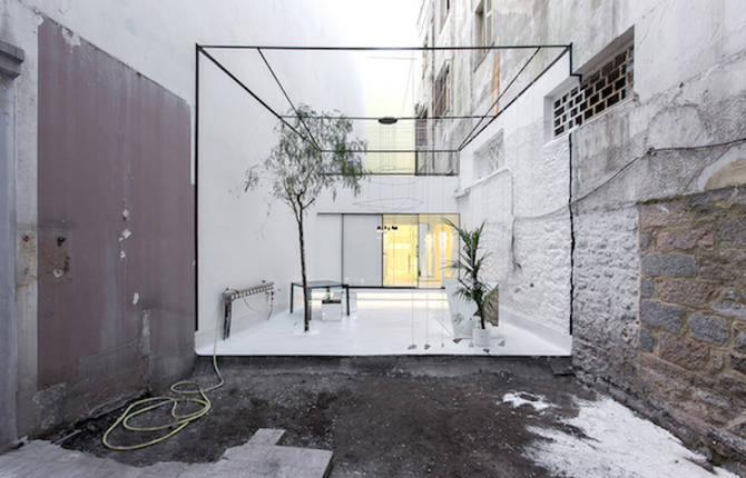 A Store Framed by an Optical Illusion of a Floating Cube Courtyard