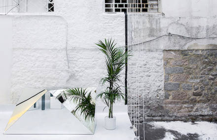 A Store Framed by an Optical Illusion of a Floating Cube Courtyard