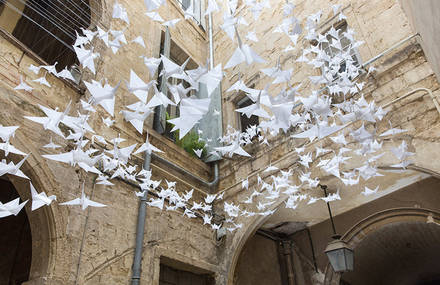 Suspended Origami Birds in a French Courtyard