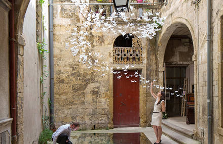 Suspended Origami Birds in a French Courtyard