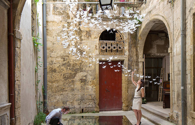 Suspended Origami Birds in a French Courtyard