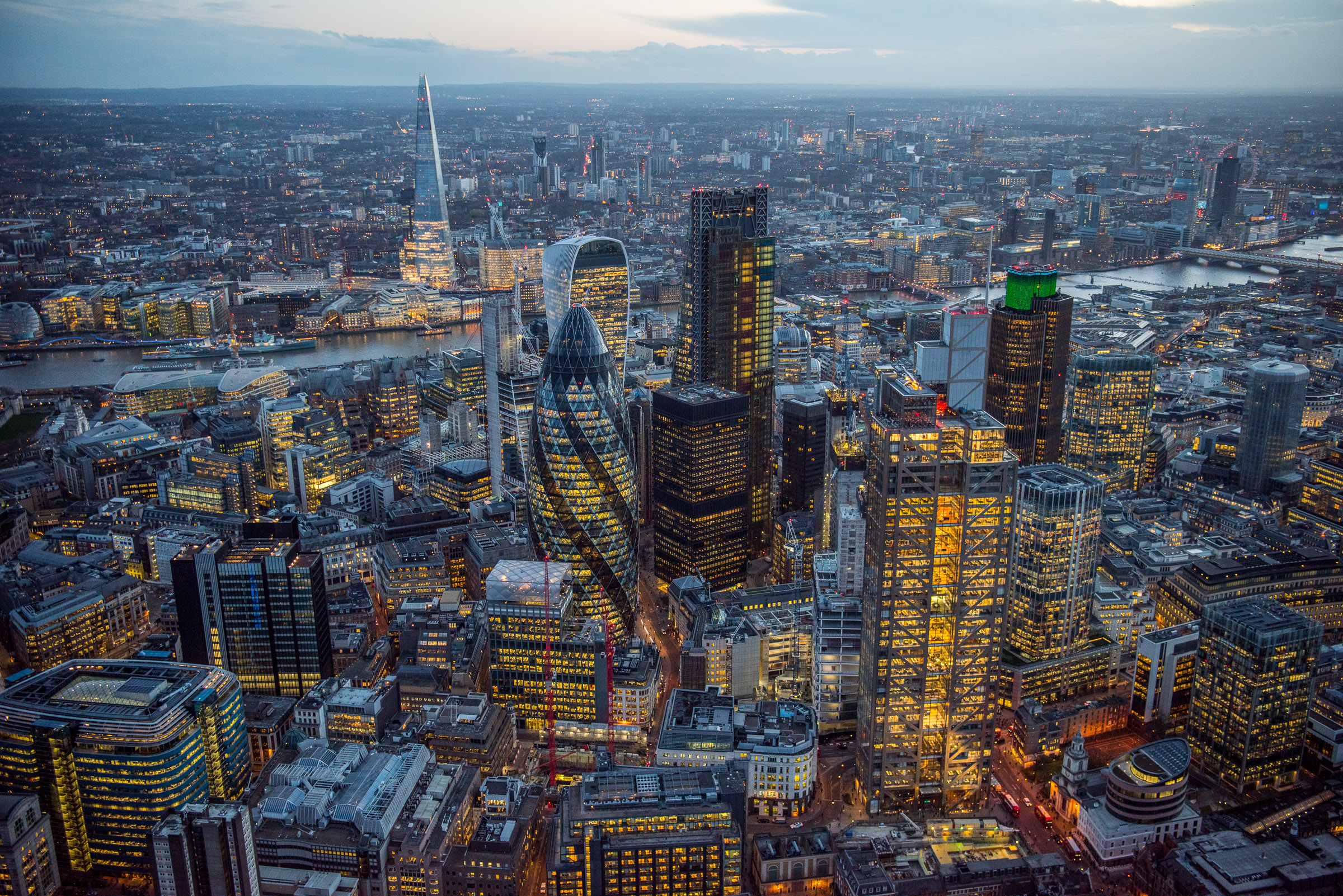 Dusk aerial view across the Square Mile / City of London . Three huge new skyscrapers, 22 Bishopsgate, The Scalpel and 100 Bishopsgate are currently under construction in the City and will again change the skyline of London enormously.