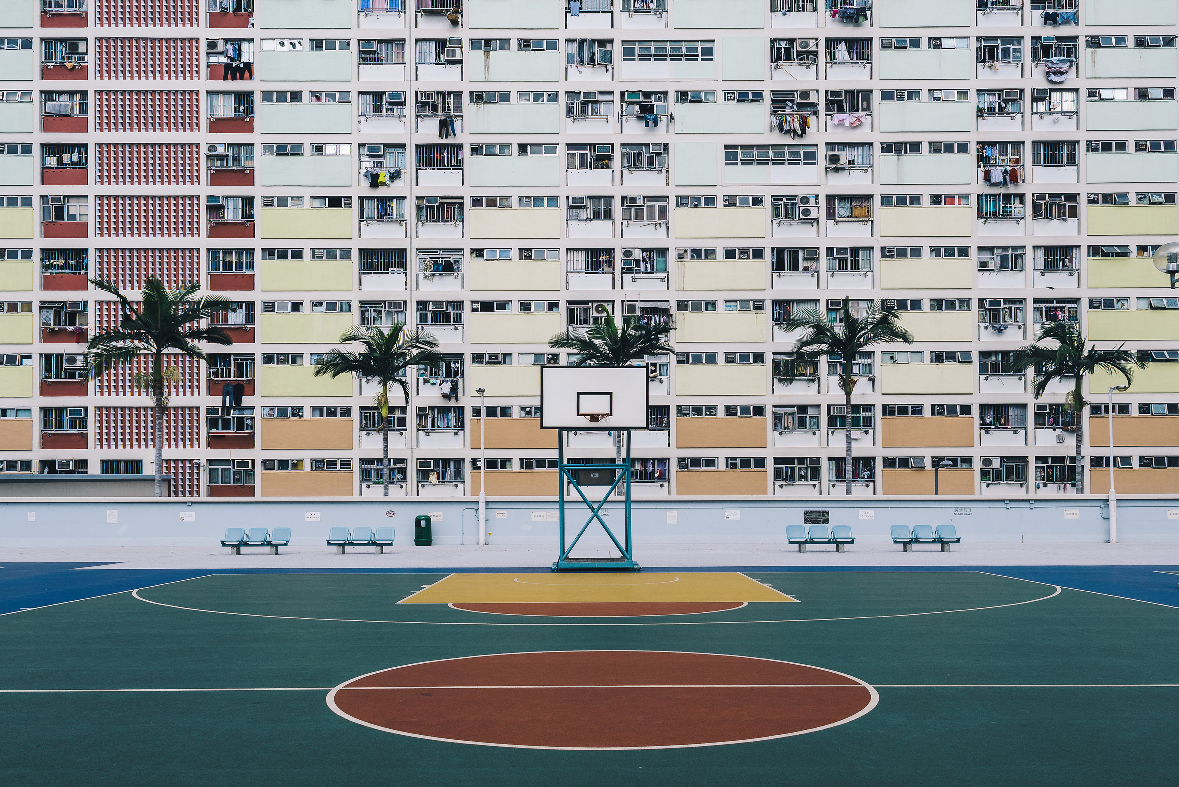 Urban Oasis - Basketball court on a pastel skyscraper front.