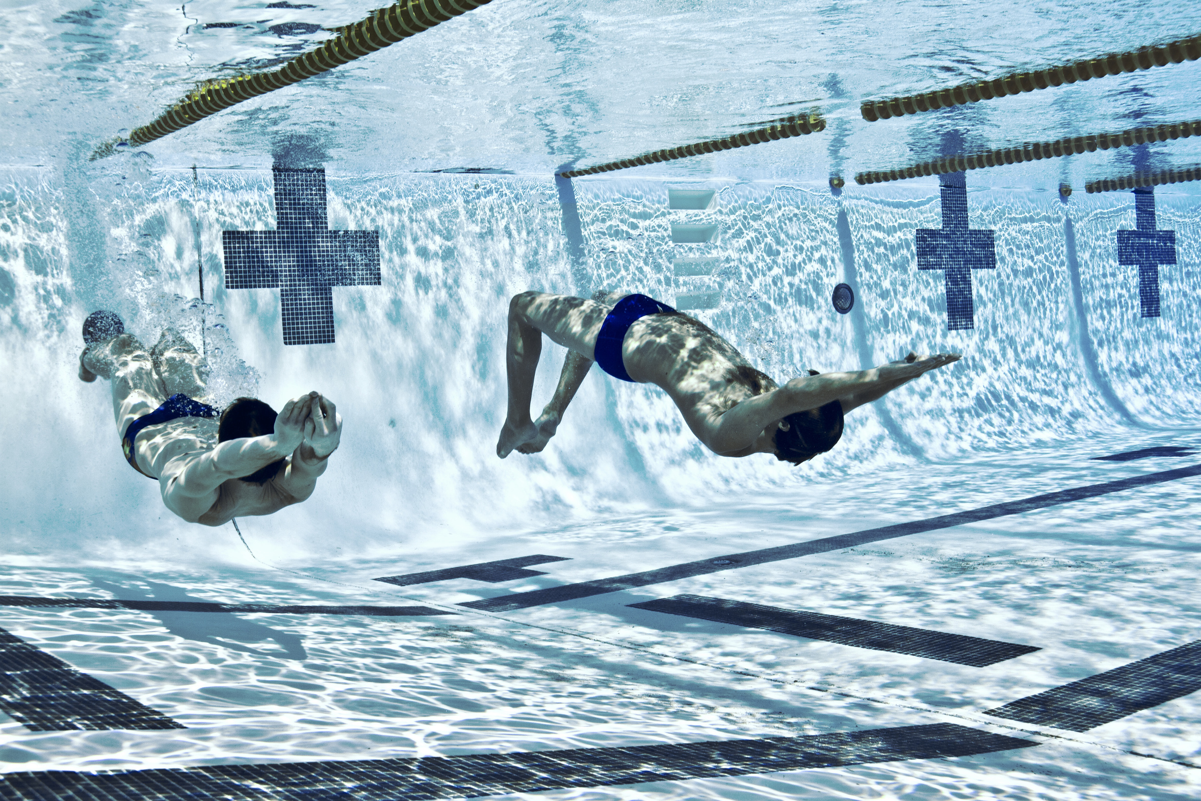 Two men racing underwater
