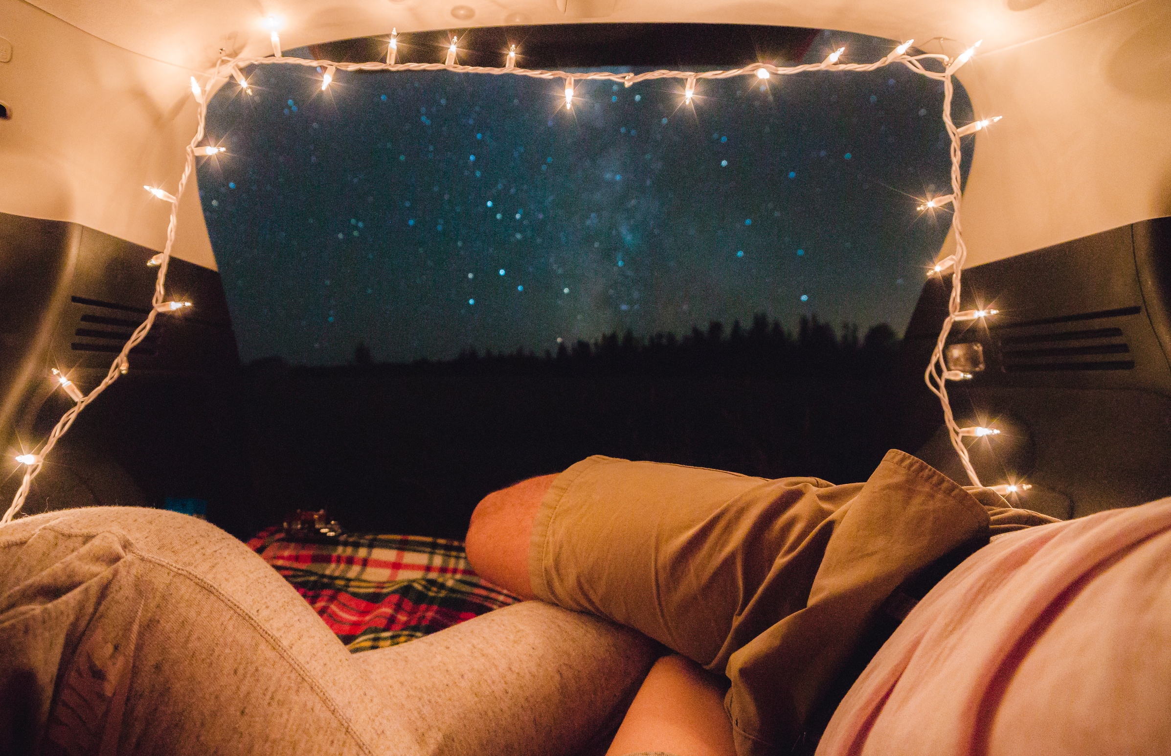 Personal perspective of night sky, as seen by couple inside tent