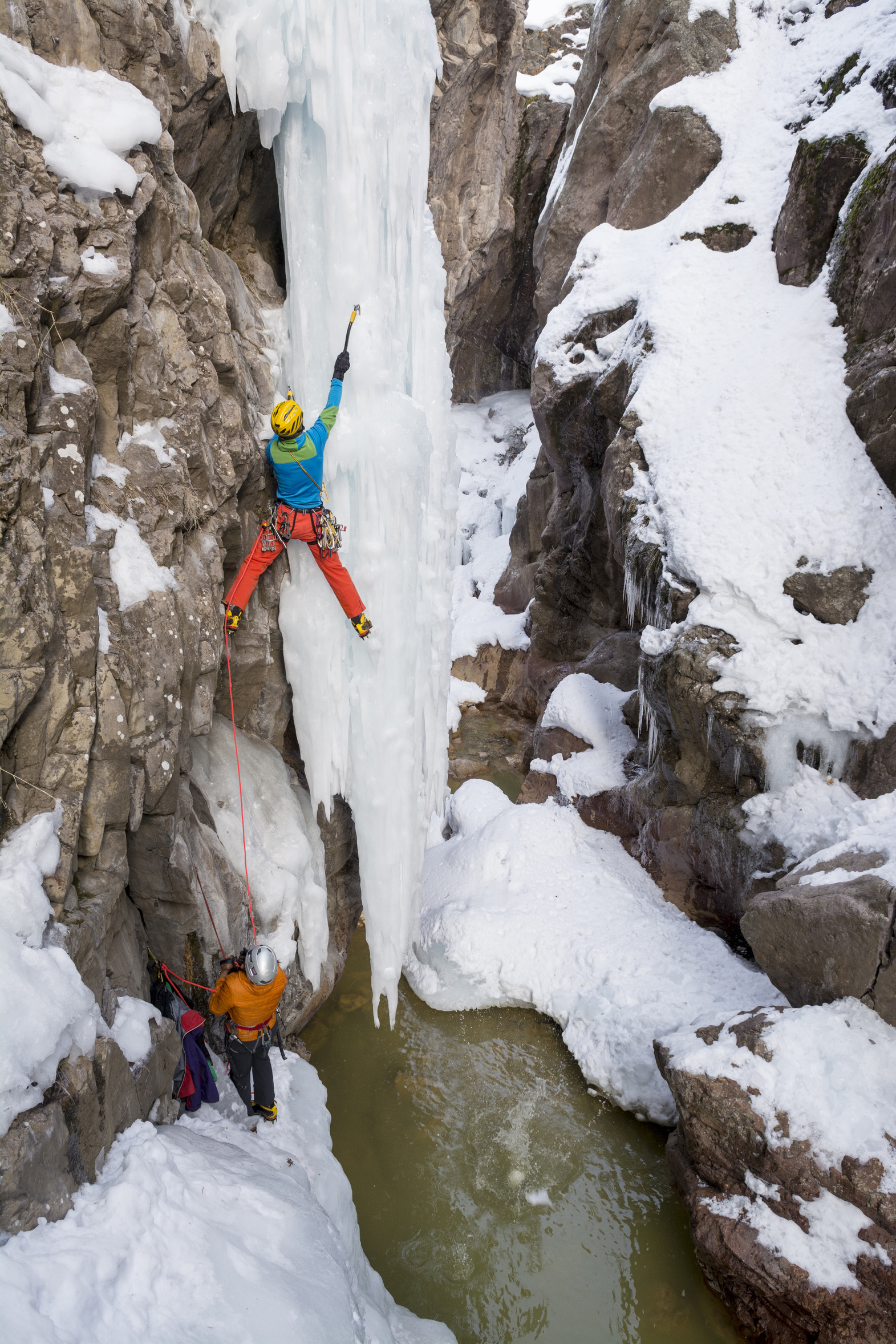 A man and woman ice climbing near Ouray, Colorado.