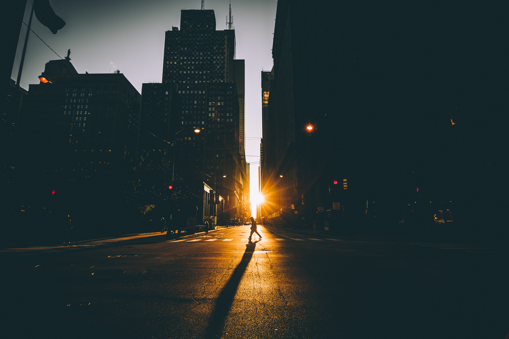 Light shining between two buildings in a city.