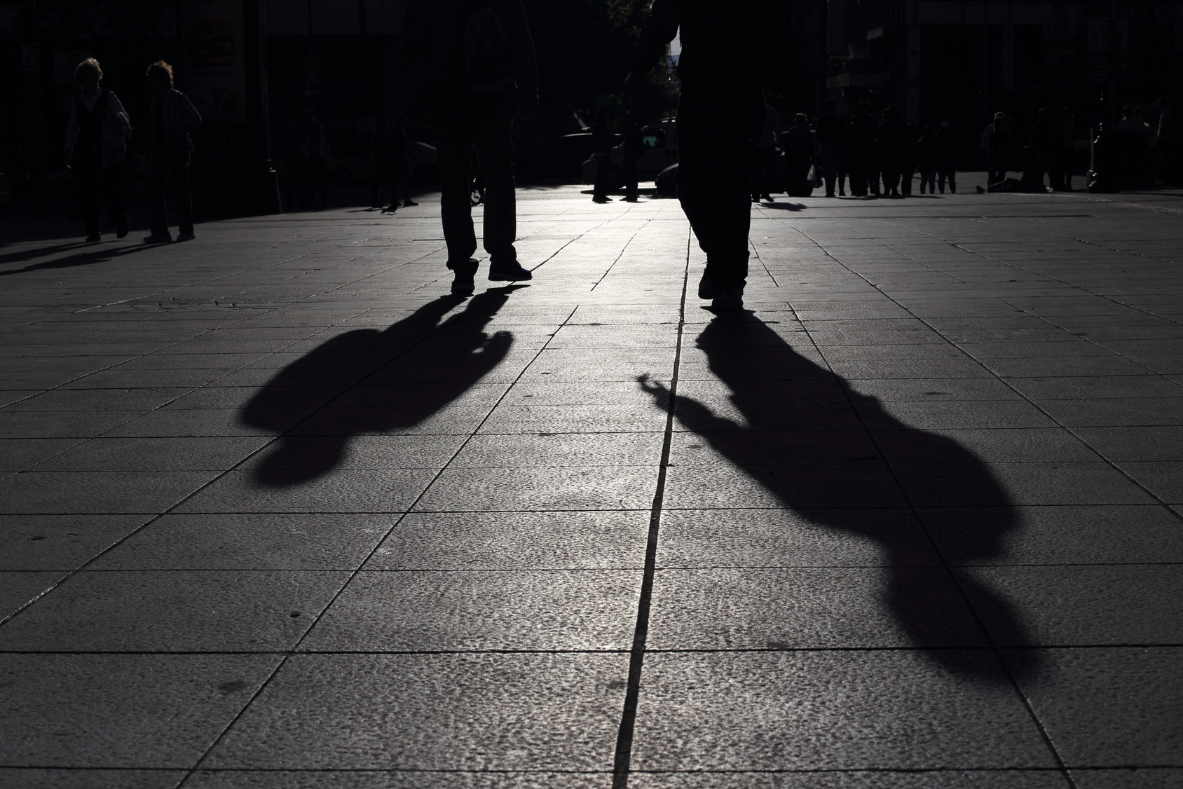 Shadows of people walking in a street of the city, Athens