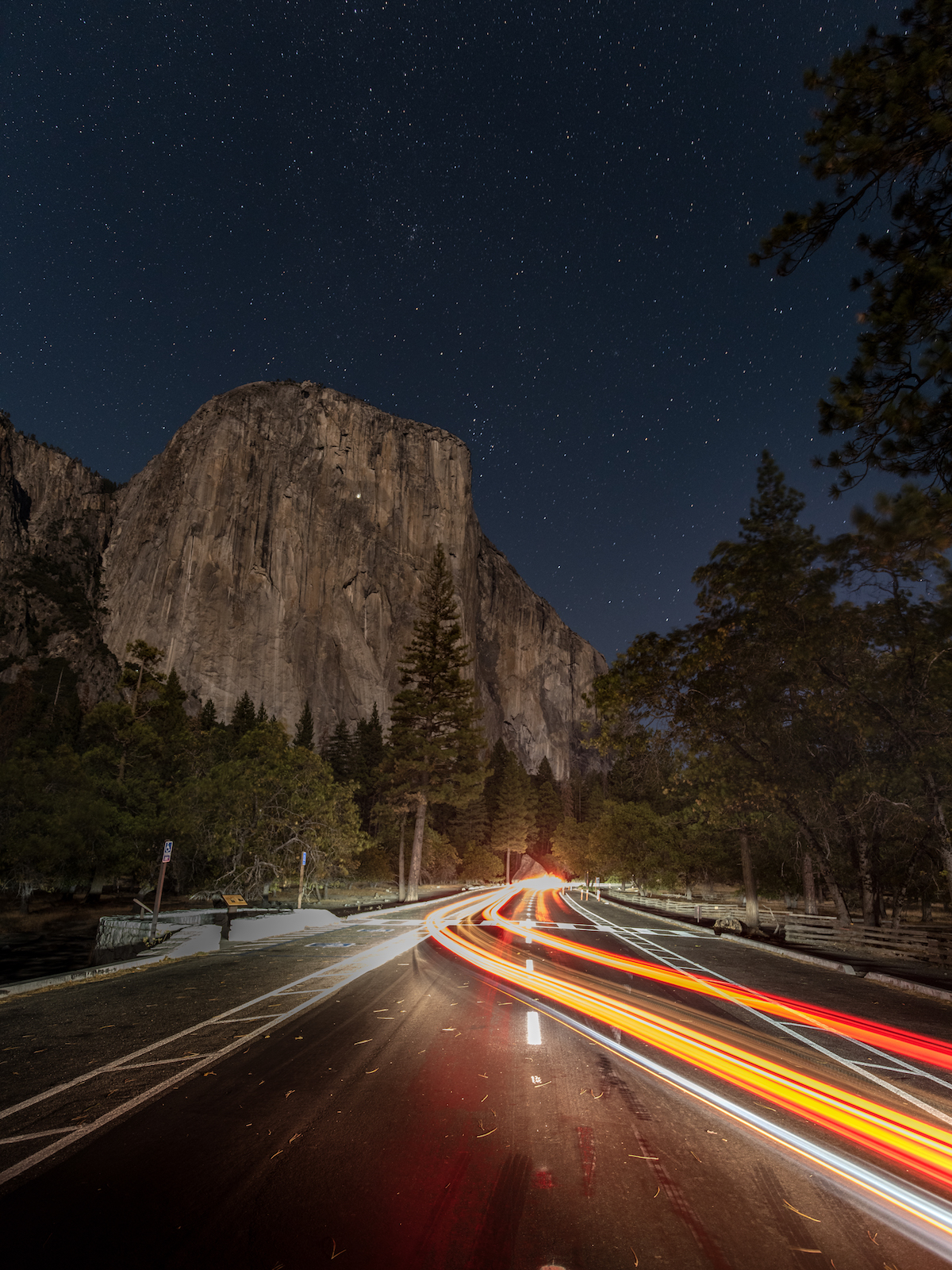 Roadway and light trails at night, El Capitan, Yosemite Valley, California, United States of America
