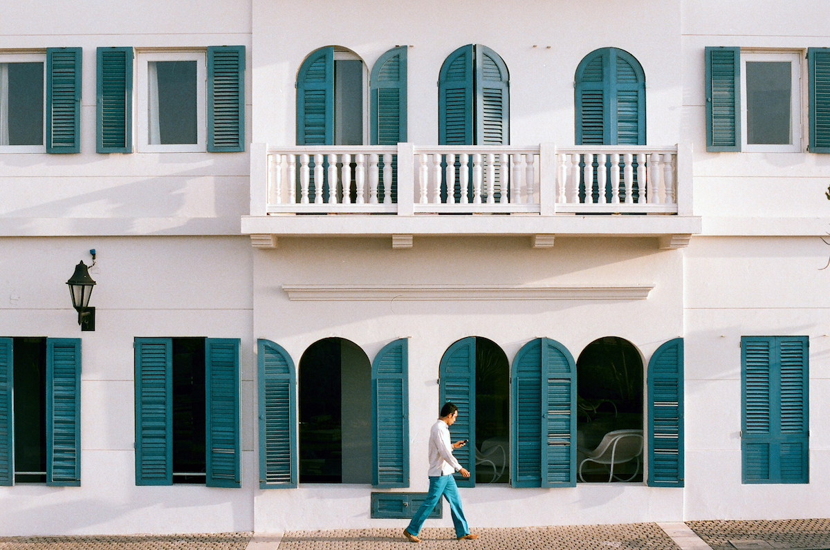 Man walking by bright building