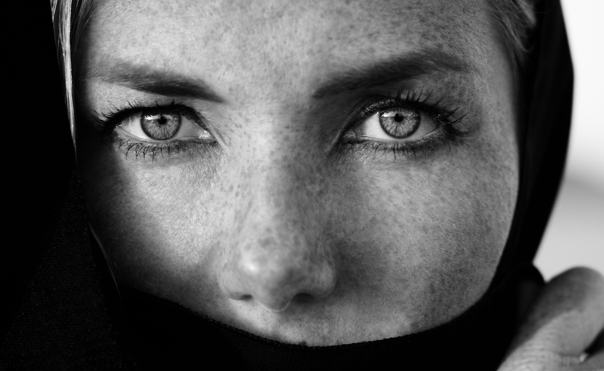 Woman face with deep eyes portrait, black and white photo session in the arabic style