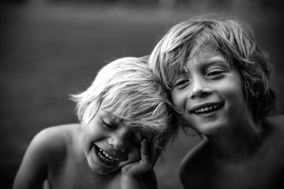 Portrait of two boys head to head, black and white