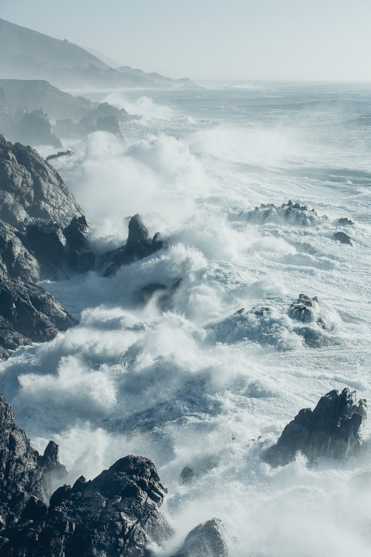 The Pacific Ocean coastline, with waves crashing against the shore.