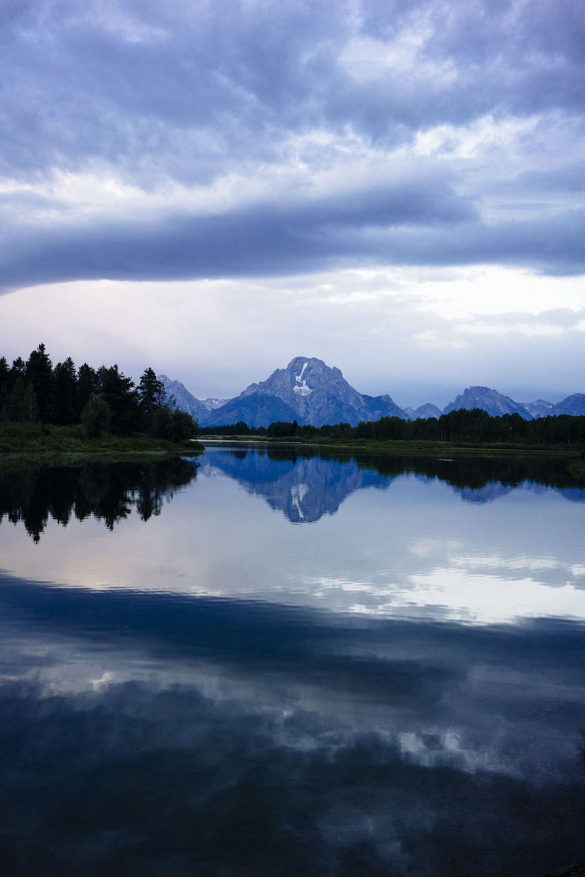 Scenic view of lake and mountain against cloudy sky at Grand Teton National Park